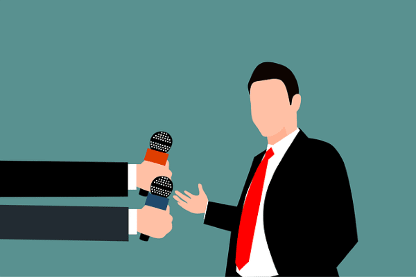 графично изображение на мъж с червена вратовръзка, застанал пред микрофони